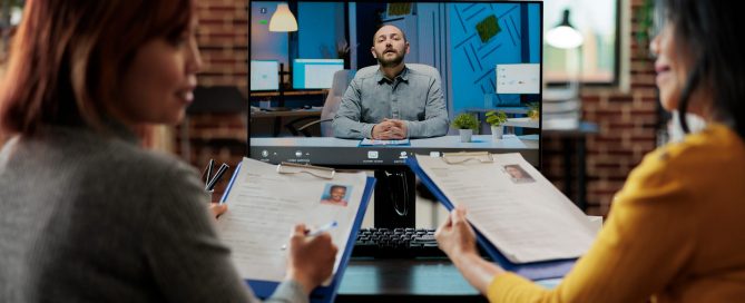 Interviewers discussing company hiring plan with applicant