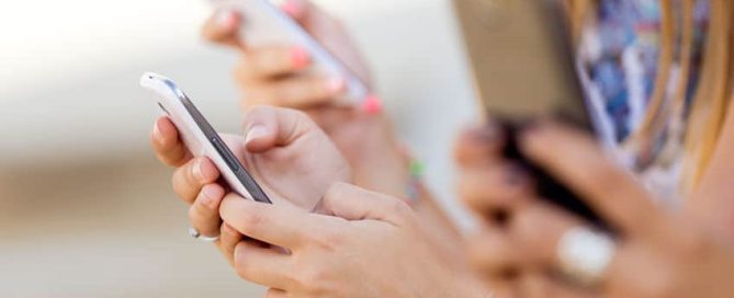 Multiple mobile phone users using their phones all at the same time.
