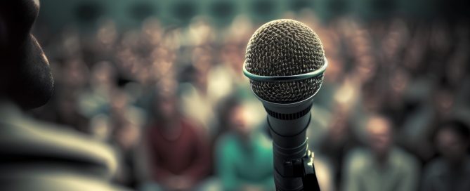 Microphone in front of a crowd at a conference hall or seminar