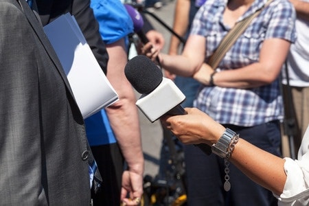 How You Can Use VT Inserts as a Marketing Edge An interviewer holding a microphone towards the interviewee.